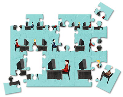 Jigsaw puzzle of businessmen working on computers in an office