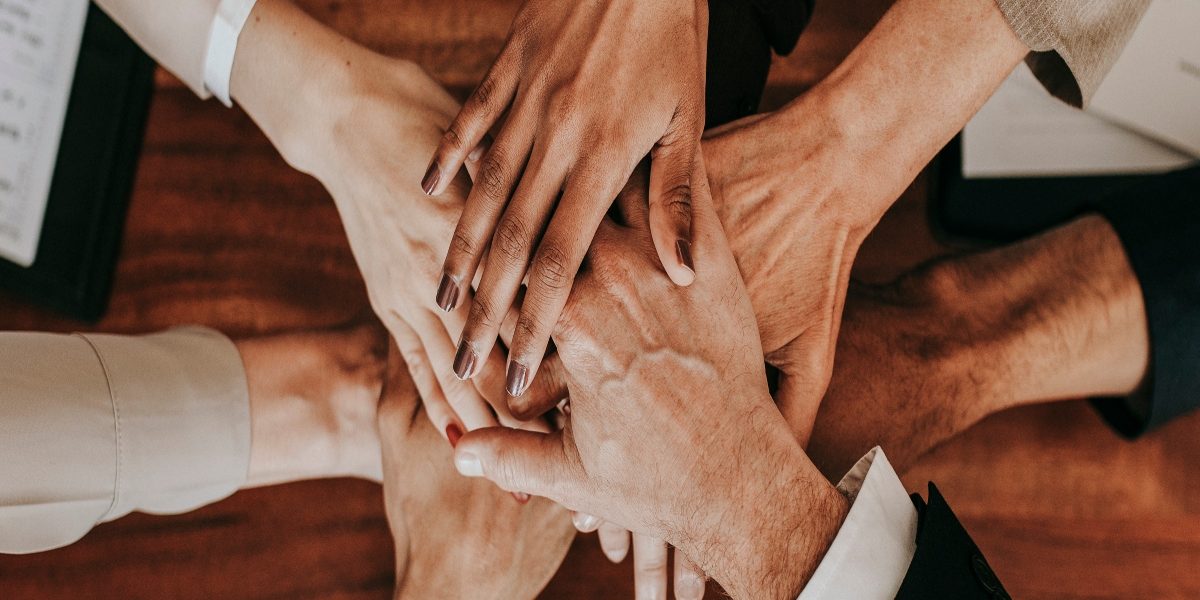 Business people stacking their hands together
