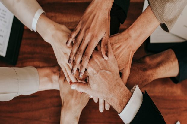 Business people stacking their hands together