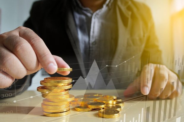 Businessman putting money coins. Business Growth concept.